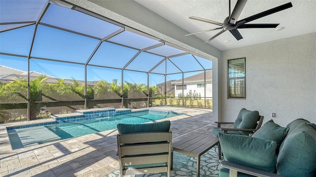 view of pool featuring pool water feature, ceiling fan, a lanai, and a patio