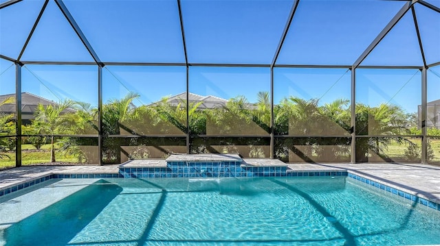 view of swimming pool featuring a lanai