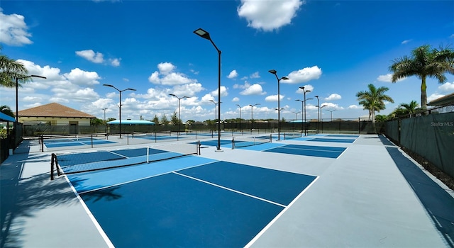 view of tennis court featuring basketball hoop