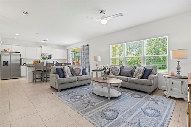 tiled living room with ceiling fan