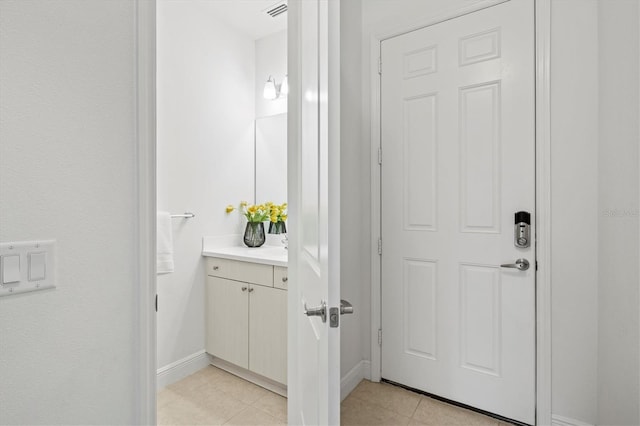 bathroom with tile patterned floors and vanity