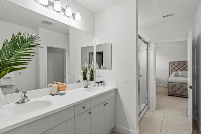 bathroom with vanity, tile patterned floors, and a shower with shower door