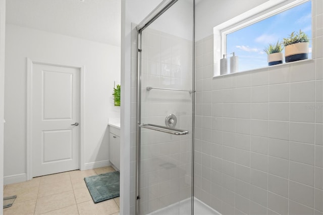 bathroom with tile patterned floors, vanity, and a shower with shower door