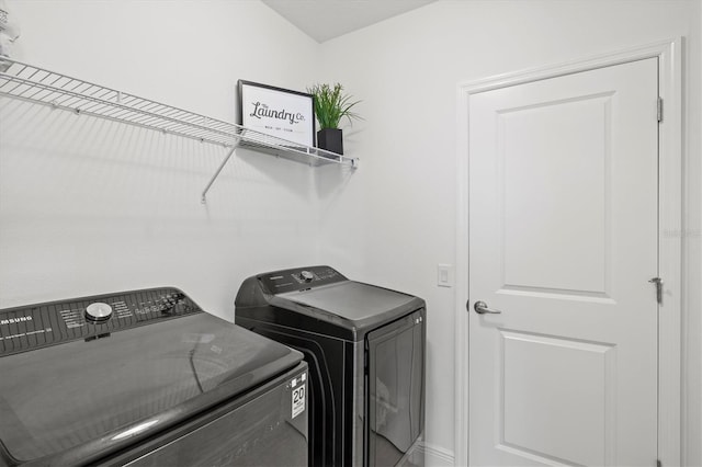 clothes washing area with washing machine and clothes dryer