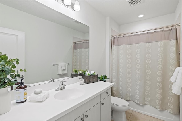 full bathroom featuring tile patterned flooring, vanity, toilet, and shower / tub combo with curtain