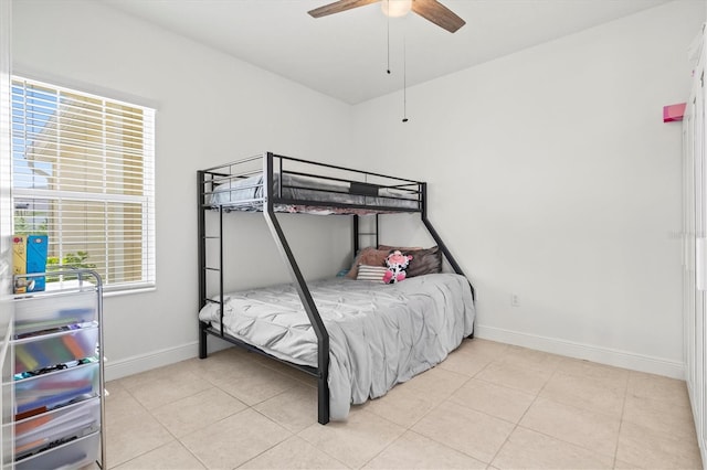 bedroom with ceiling fan and light tile patterned flooring