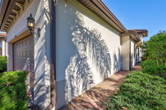 view of side of property featuring a garage