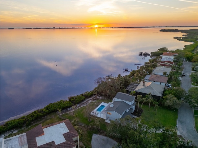 aerial view at dusk with a water view