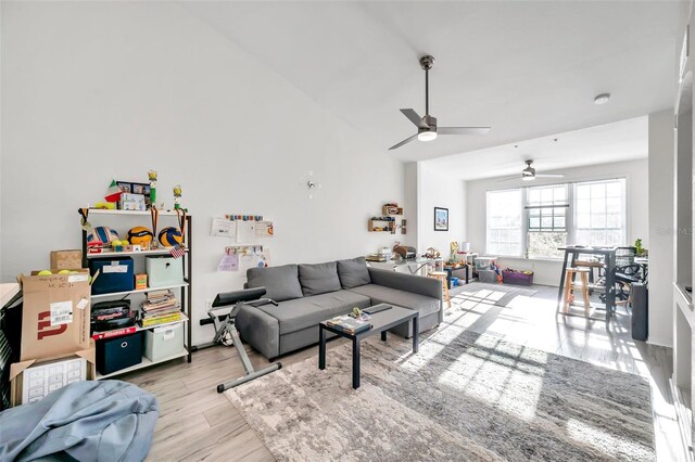 living room with light hardwood / wood-style floors and ceiling fan