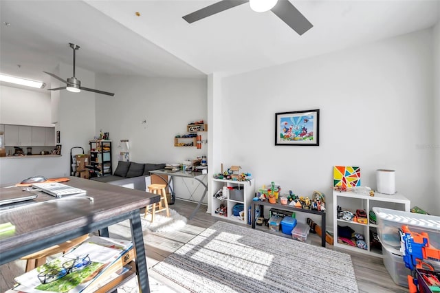 interior space with ceiling fan, light hardwood / wood-style floors, and lofted ceiling