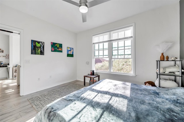 bedroom with ceiling fan and light hardwood / wood-style floors