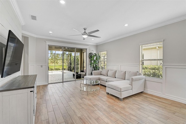 living room with crown molding and light hardwood / wood-style flooring