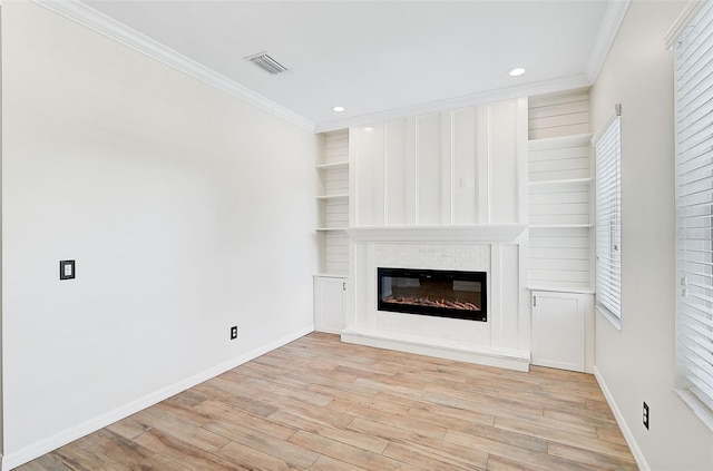 unfurnished living room with light hardwood / wood-style floors and ornamental molding