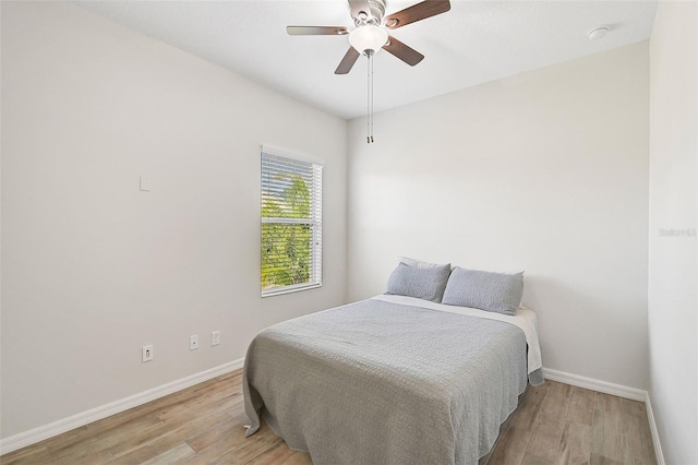 bedroom with light hardwood / wood-style flooring and ceiling fan