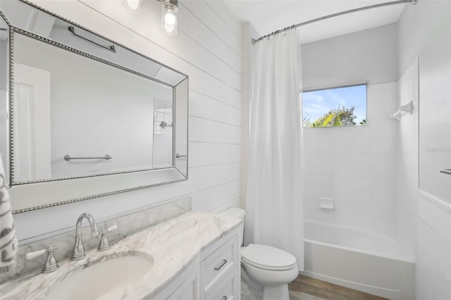 full bathroom featuring hardwood / wood-style floors, vanity, toilet, and shower / bath combo