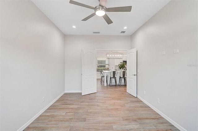 corridor with light hardwood / wood-style floors