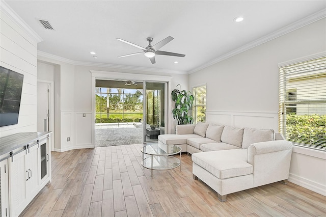 living room with light hardwood / wood-style flooring and ornamental molding