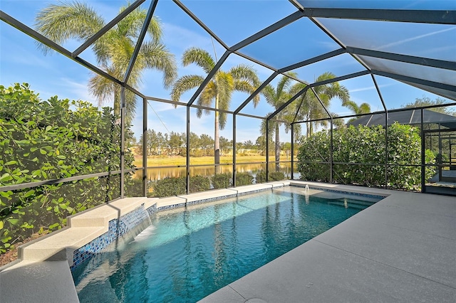 view of pool with glass enclosure, pool water feature, and a water view