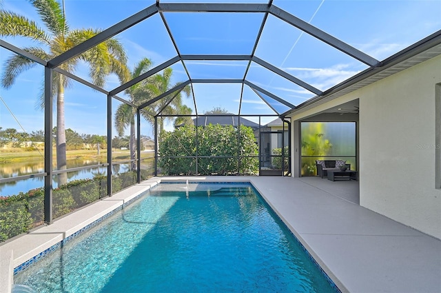 view of pool with a lanai, a patio area, ceiling fan, and a water view