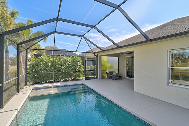 view of swimming pool with a patio, pool water feature, ceiling fan, and a lanai