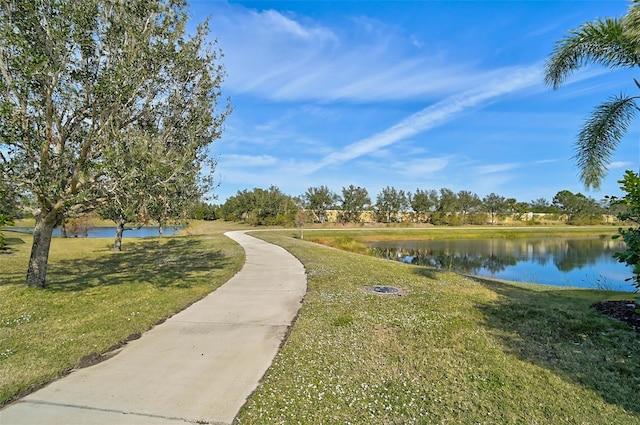 view of property's community with a yard and a water view