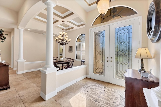 tiled entrance foyer featuring coffered ceiling, an inviting chandelier, beam ceiling, and french doors