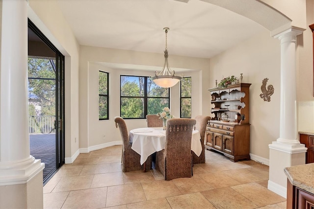 dining area with ornate columns and light tile patterned flooring