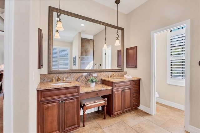 bathroom with tile patterned flooring, vanity, and toilet