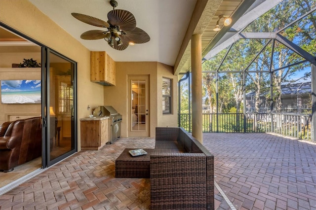 sunroom featuring ceiling fan