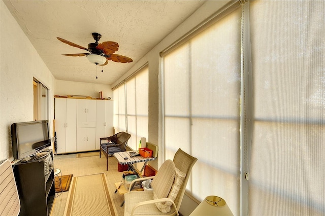 sunroom / solarium featuring ceiling fan