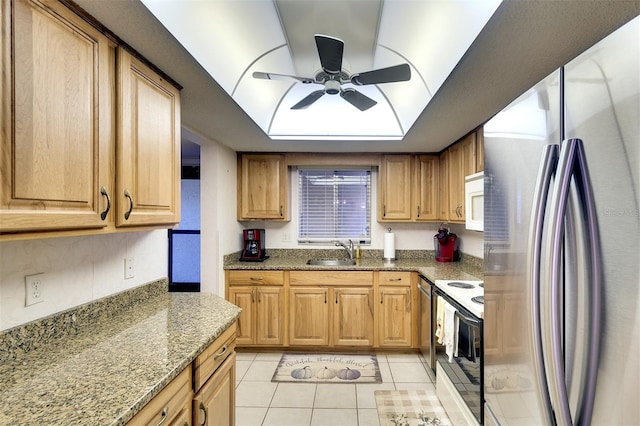 kitchen with stone counters, sink, electric range, stainless steel fridge, and light tile patterned floors