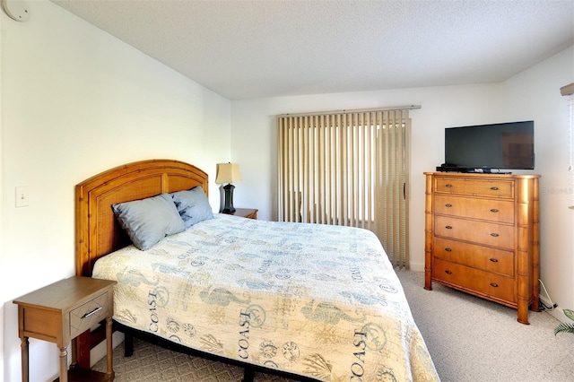 carpeted bedroom featuring a textured ceiling