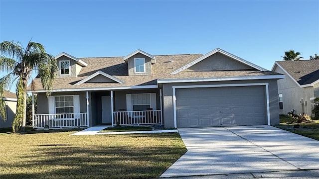 view of front facade with a garage, covered porch, and a front yard