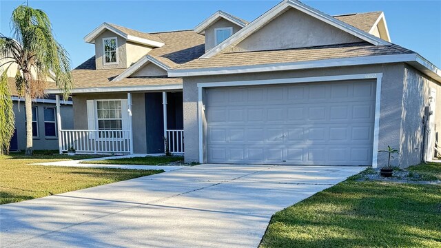 4042 Kingsfield Dr, Parrish, FL 34219 - view of front of house with stucco siding, roof with shingles, and a porch