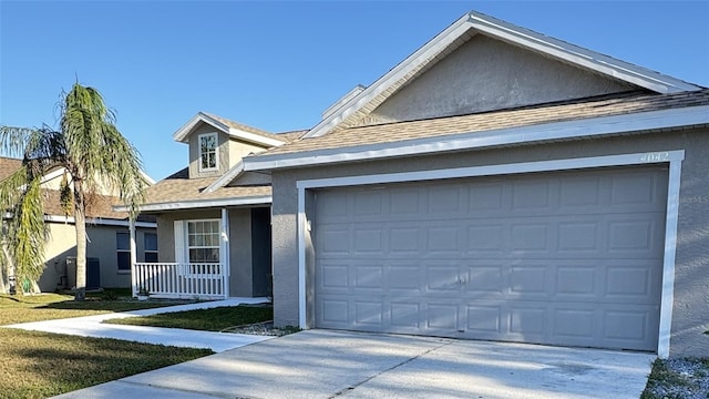 4042 Kingsfield Dr, Parrish, FL 34219 - single story home featuring stucco siding, roof with shingles, driveway, an attached garage, and a porch
