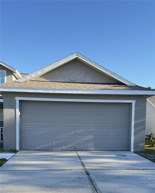 4042 Kingsfield Dr, Parrish, FL 34219 - view of front of house featuring driveway, stucco siding, and an attached garage