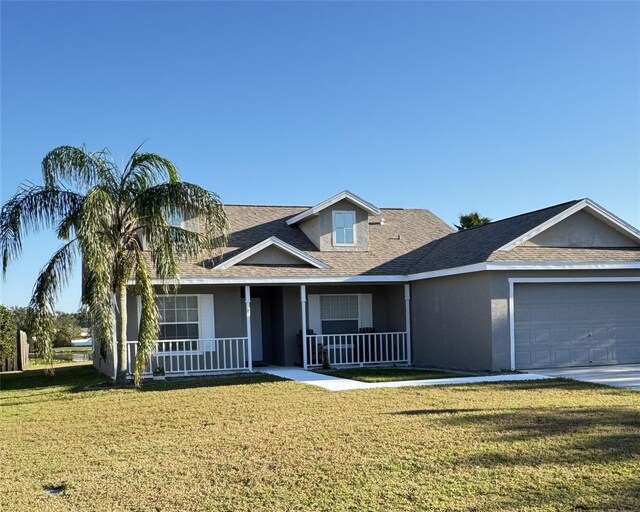 4042 Kingsfield Dr, Parrish, FL 34219 - view of front of property featuring stucco siding, a front yard, covered porch, a garage, and concrete driveway