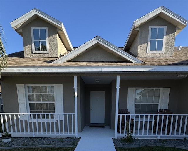 view of exterior entry featuring a porch