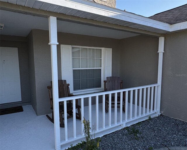 4042 Kingsfield Dr, Parrish, FL 34219 - doorway to property with stucco siding and covered porch