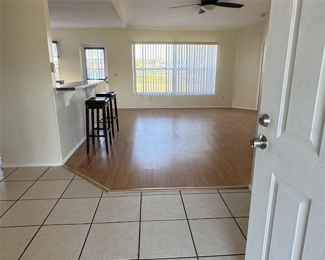 unfurnished dining area featuring ceiling fan and light hardwood / wood-style floors