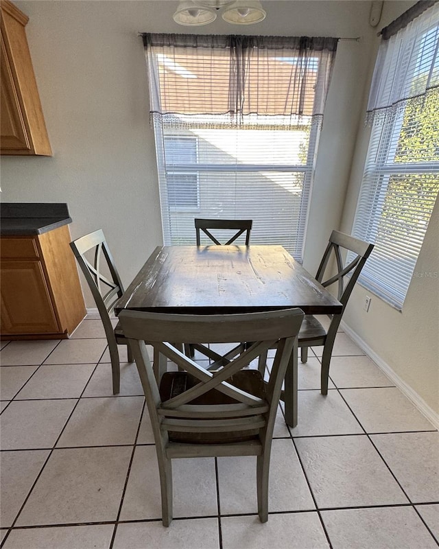 dining area featuring light tile patterned floors and a healthy amount of sunlight