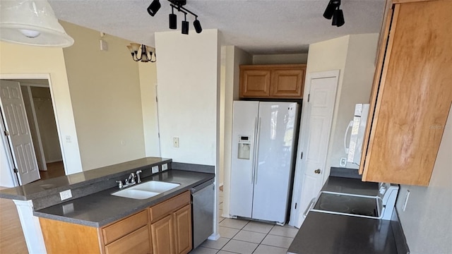 4042 Kingsfield Dr, Parrish, FL 34219 - kitchen with white appliances, a sink, dark countertops, light tile patterned flooring, and a textured ceiling