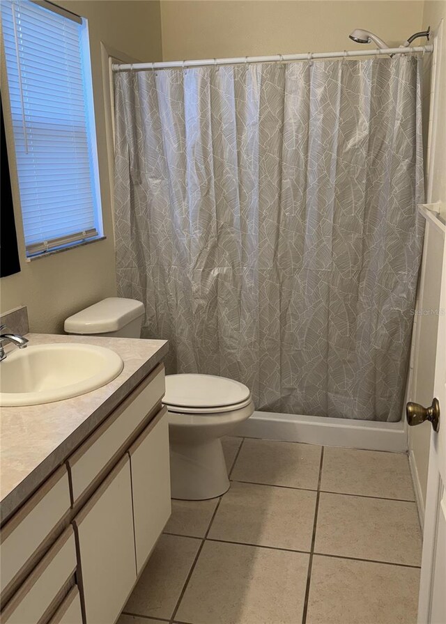 4042 Kingsfield Dr, Parrish, FL 34219 - bathroom featuring vanity, toilet, tile patterned floors, and a shower with curtain