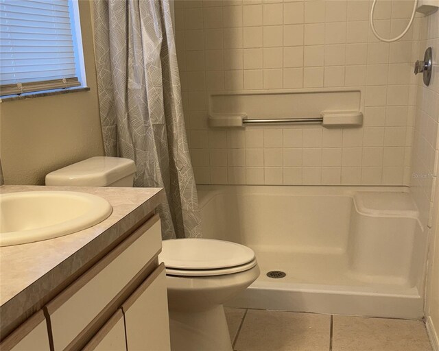 4042 Kingsfield Dr, Parrish, FL 34219 - full bathroom with vanity, curtained shower, tile patterned flooring, and toilet