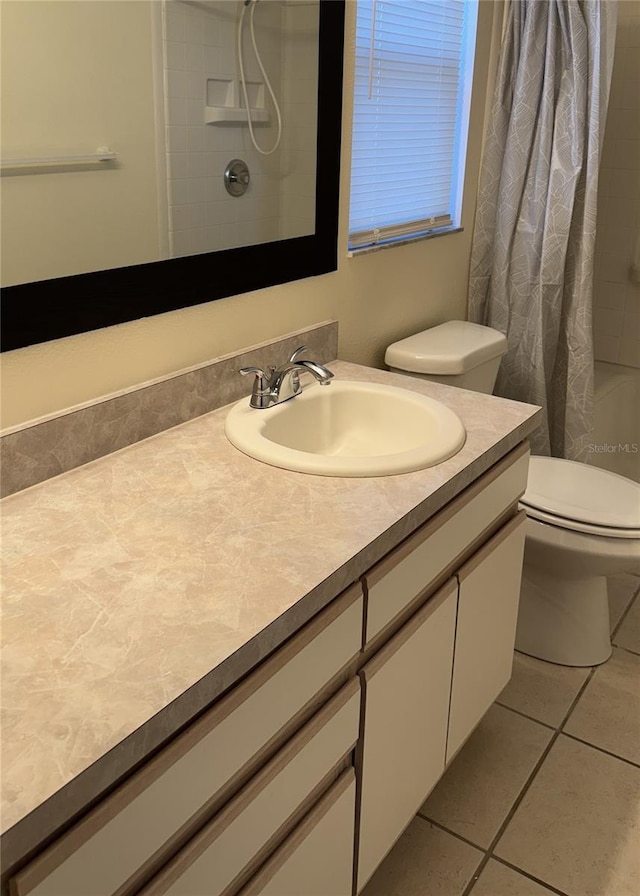 bathroom featuring tile patterned floors, vanity, and toilet