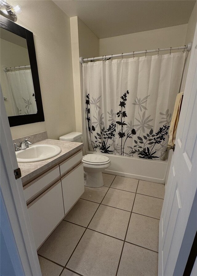 4042 Kingsfield Dr, Parrish, FL 34219 - full bathroom with vanity, toilet, tile patterned floors, and shower / bath combination with curtain