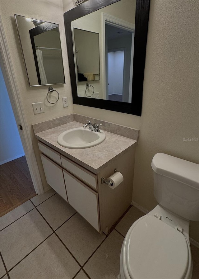 4042 Kingsfield Dr, Parrish, FL 34219 - bathroom with vanity, toilet, tile patterned floors, and baseboards