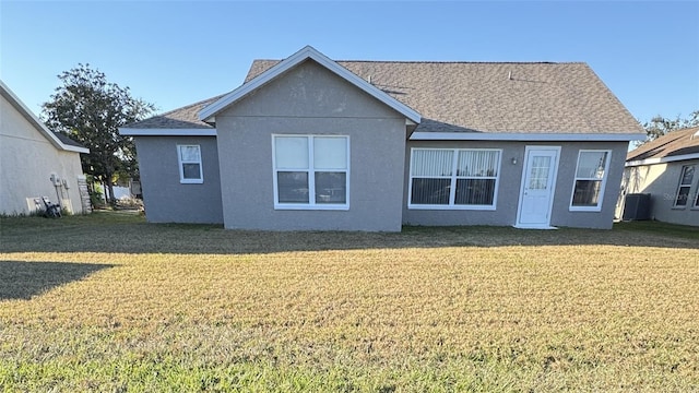 4042 Kingsfield Dr, Parrish, FL 34219 - back of house with a yard, stucco siding, and a shingled roof