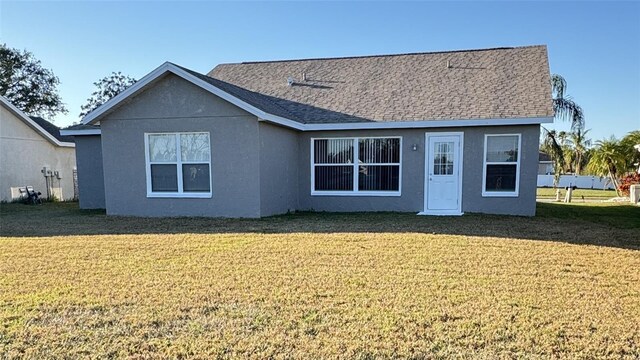 4042 Kingsfield Dr, Parrish, FL 34219 - back of house with a lawn and stucco siding