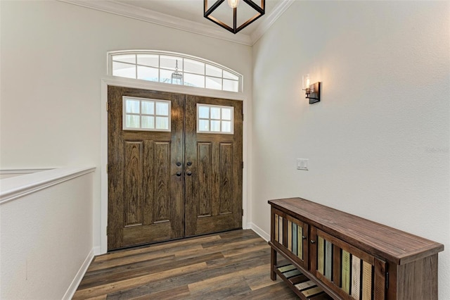 foyer with dark wood-type flooring and crown molding